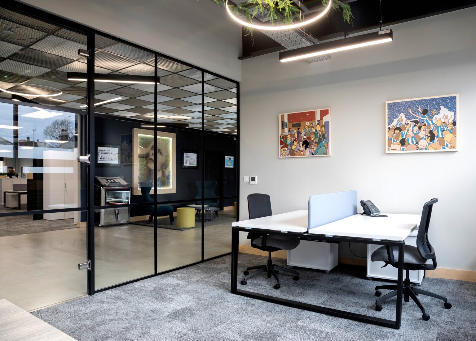Image of desk in glass office looking out into main reception