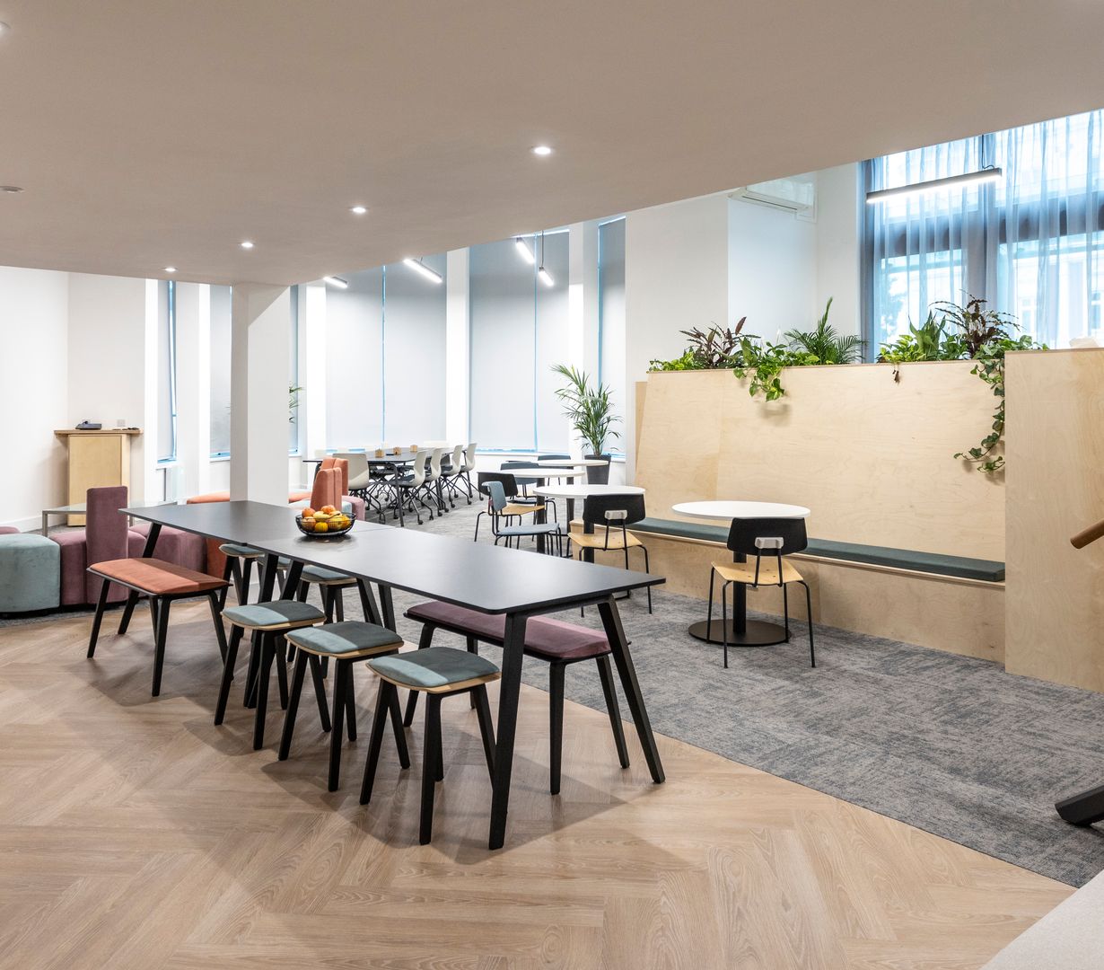 Image of communal area with seating and tables for eting