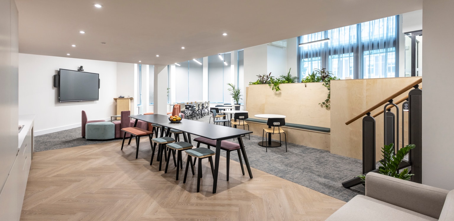 Image of communal area with seating and tables for eting