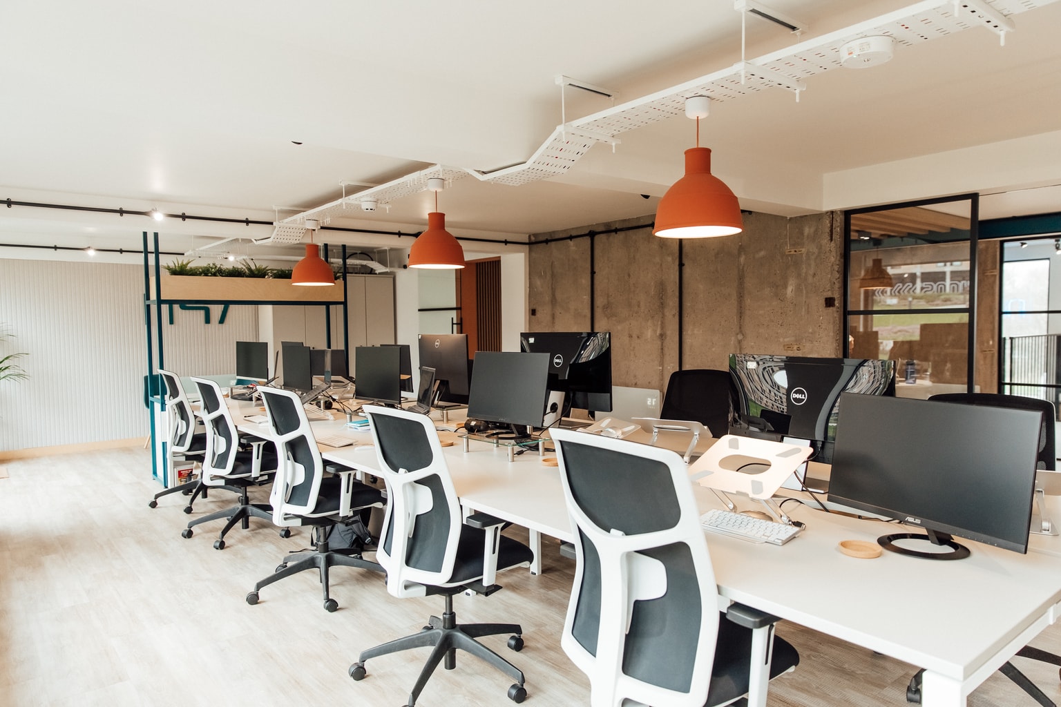 Image of offices desk and seating with terracotta lighting above