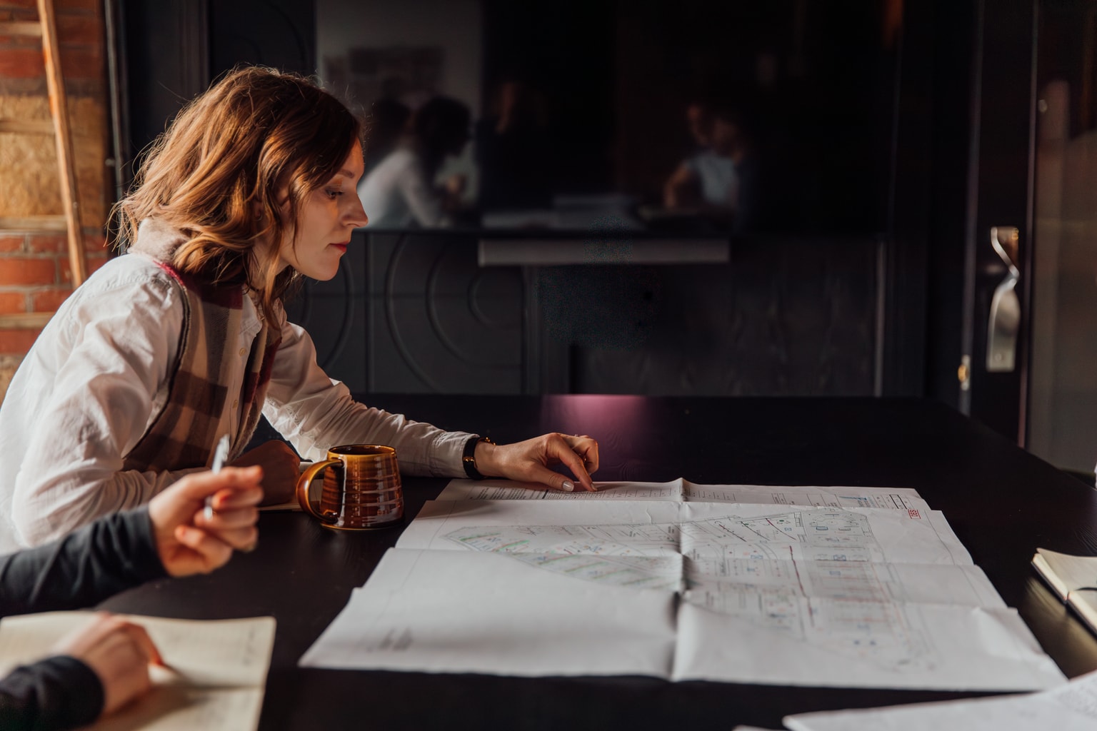 Image of individuals discussing construction drawings