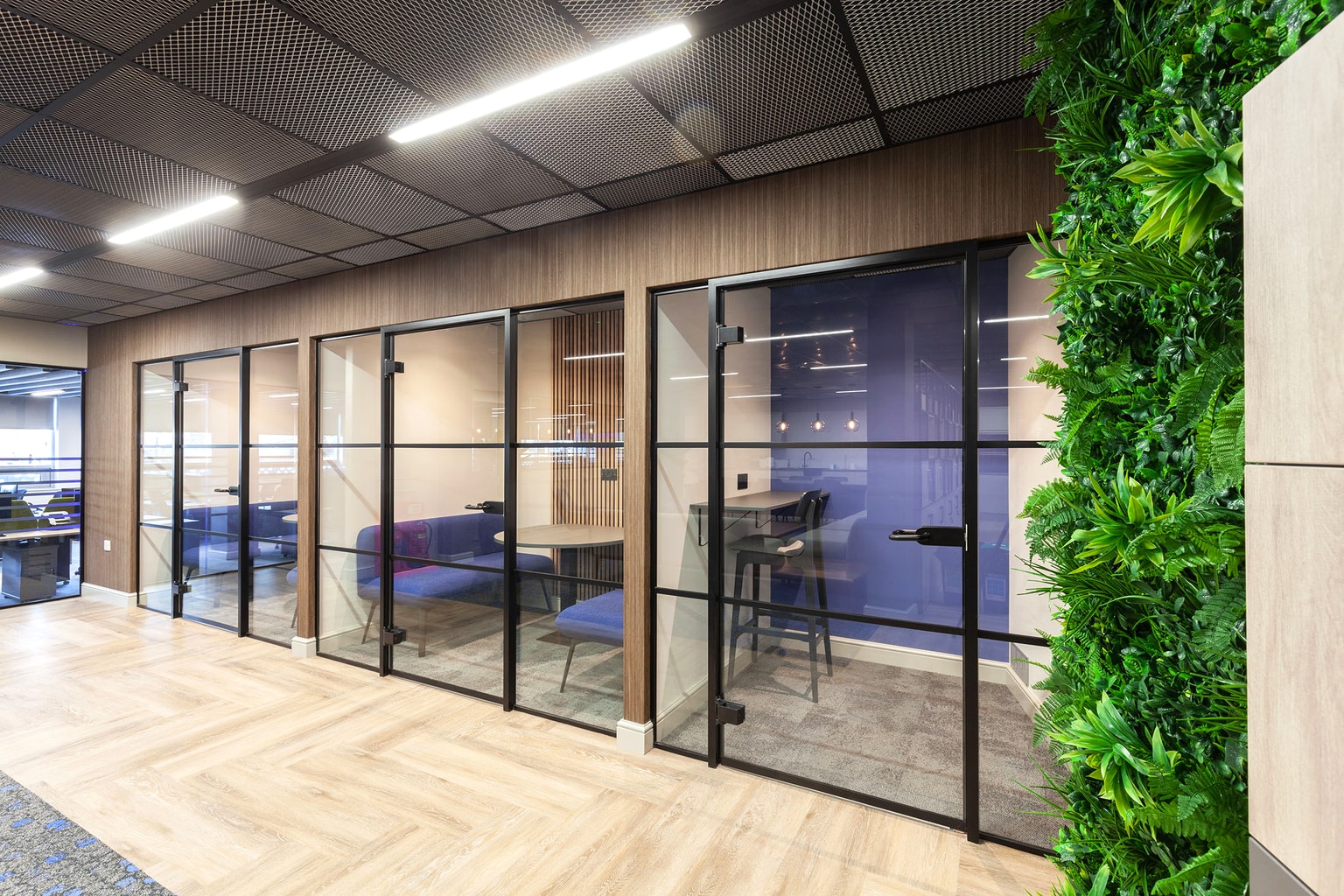 Image of quiet booths lined by glass panels with comfy seating inside