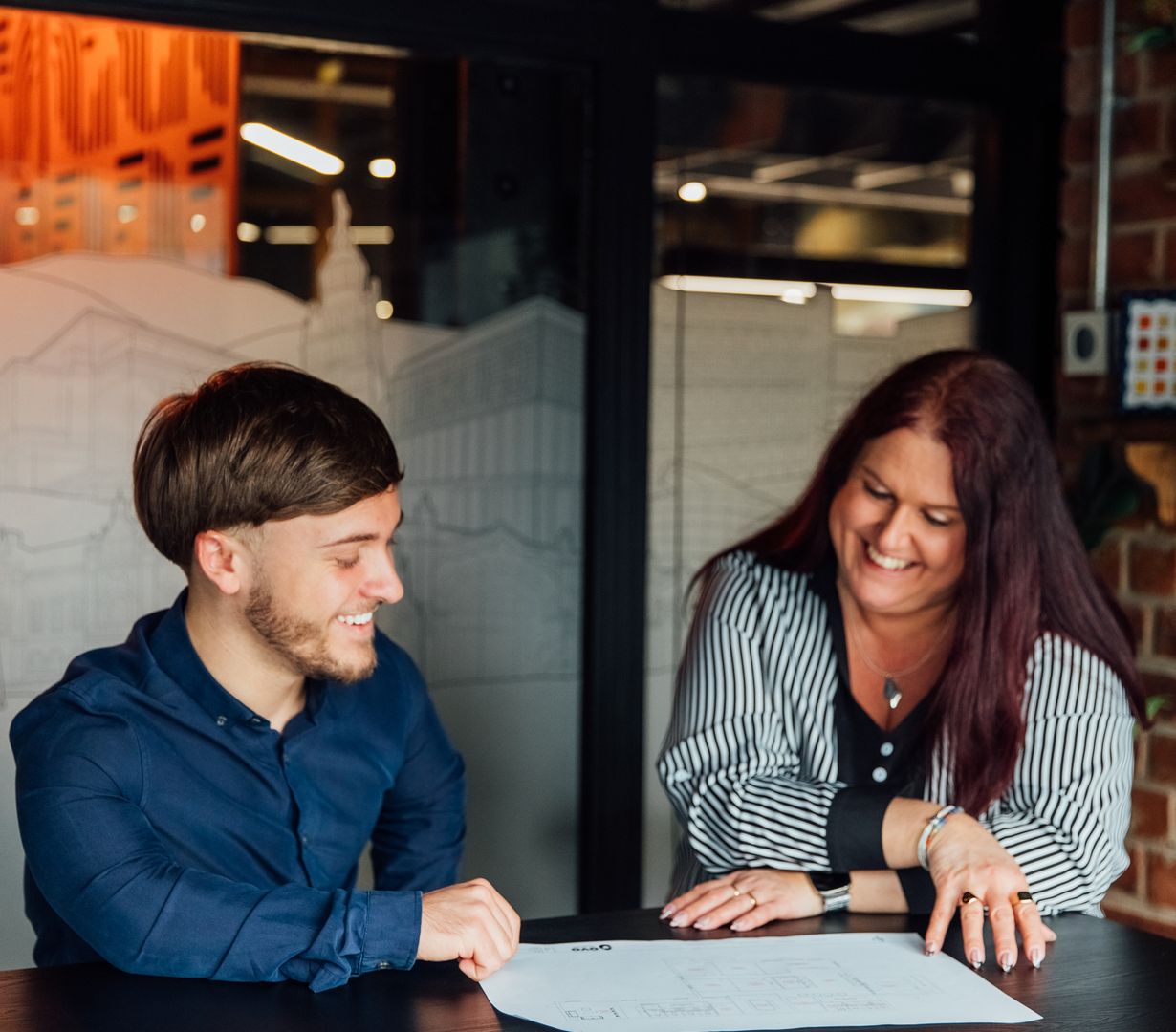 Image of colleagues discussing drawings