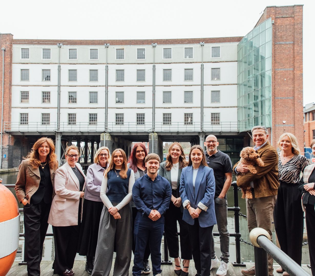 Group photo of the Ovo Space's team outside on the pontoon